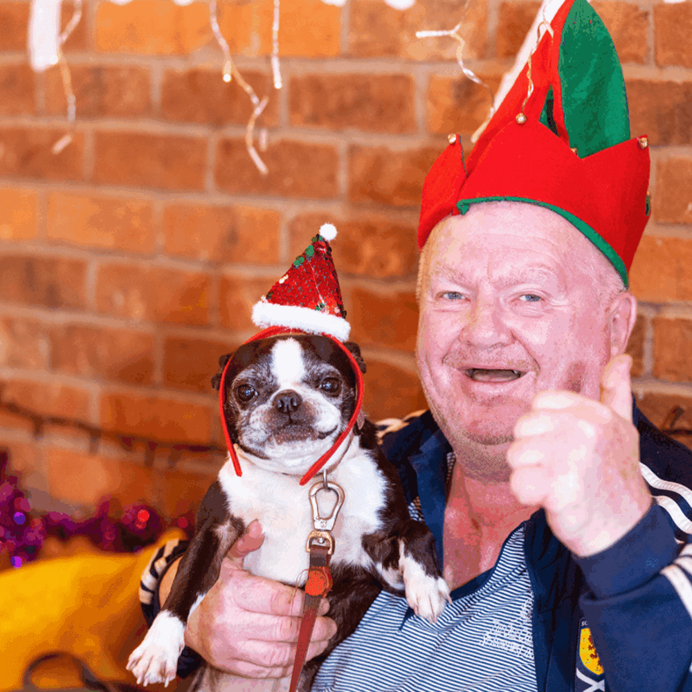 Jim and his dog Minnie in Christmas hats