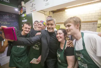 George Clooney takes a selfie with four staff at Social Bite