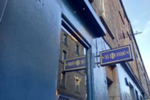 Exterior of a restaurant, blue walls and a sign that reads 'Bon Vivant'